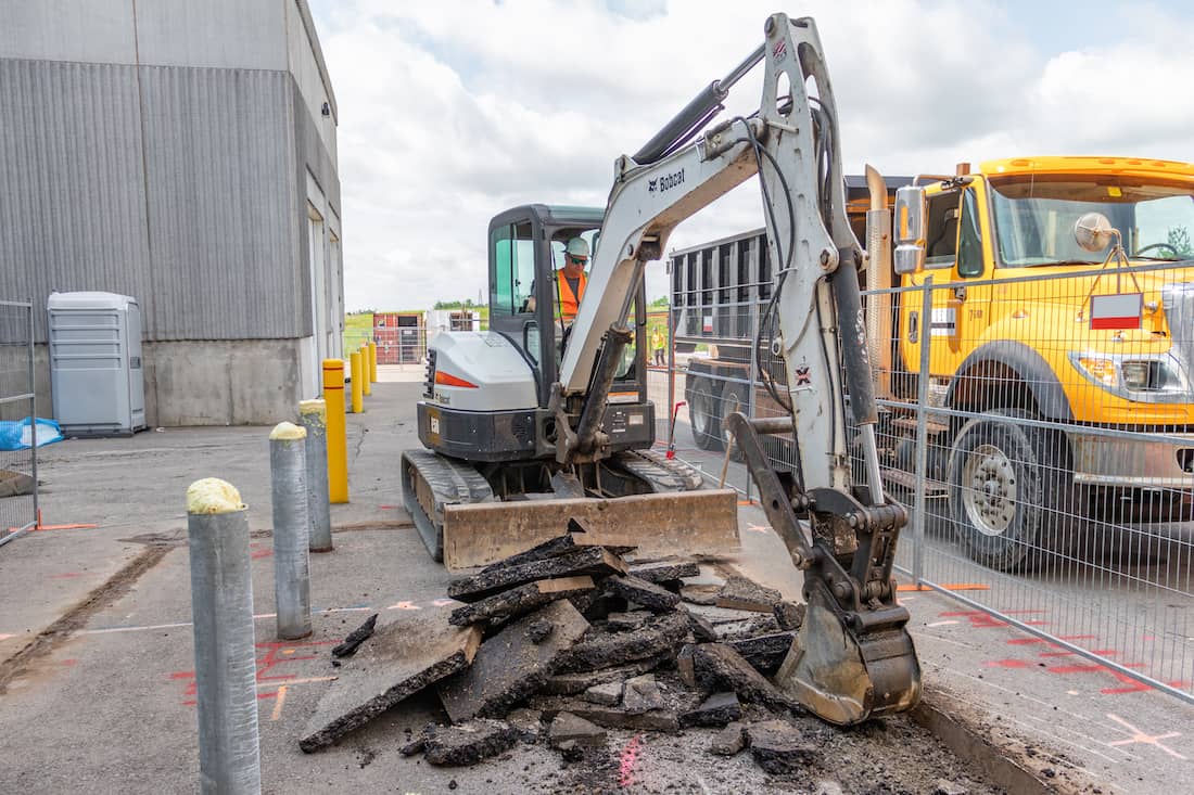 mini excavator rental doing road work